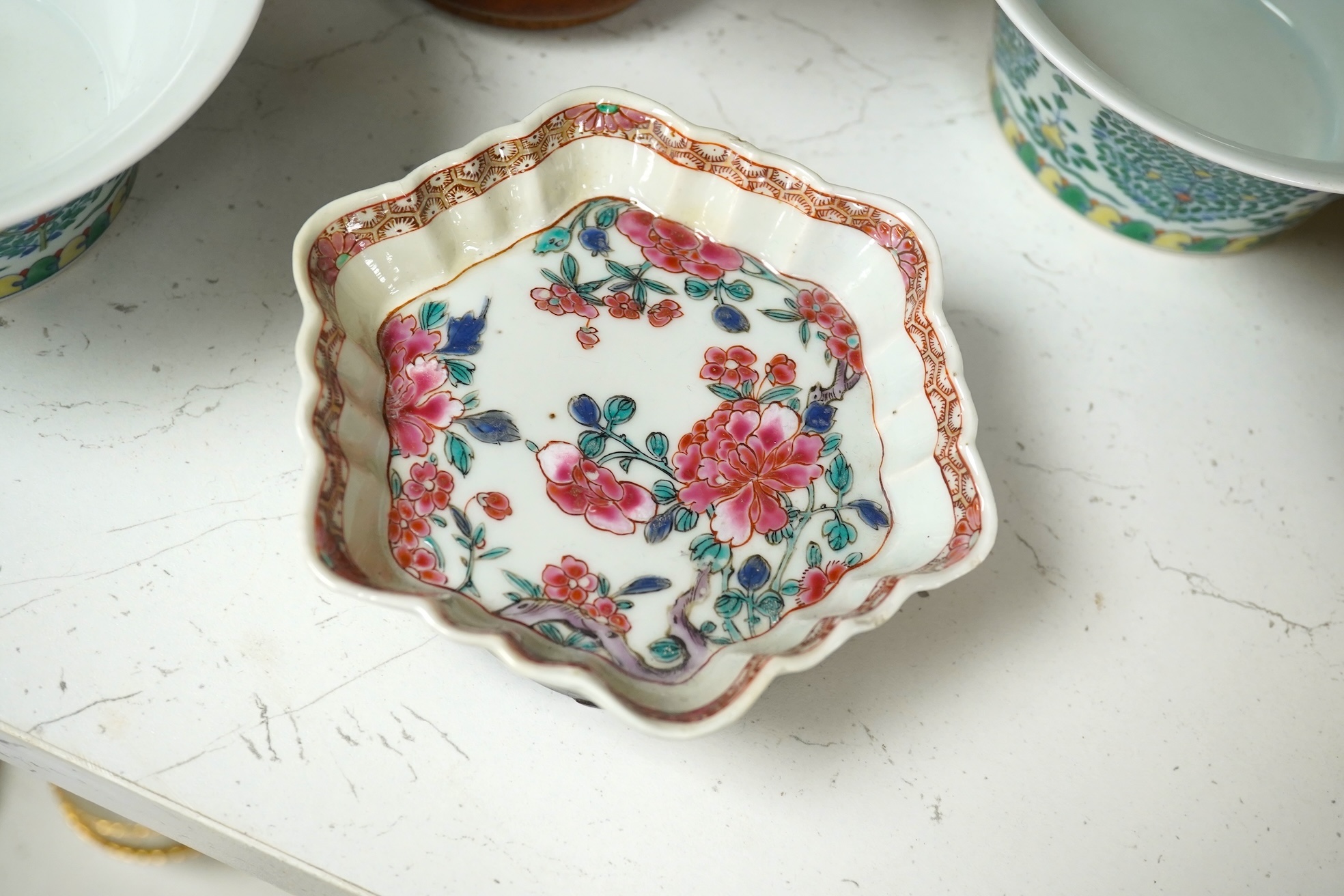 A Chinese blue and white bowl, Kangxi, 15cm. diam., a famille rose teapot stand, Yongzheng, and two doucai bowls. Condition - varies